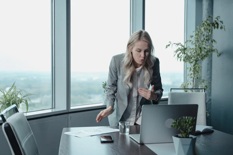 A standing woman in a video meeting